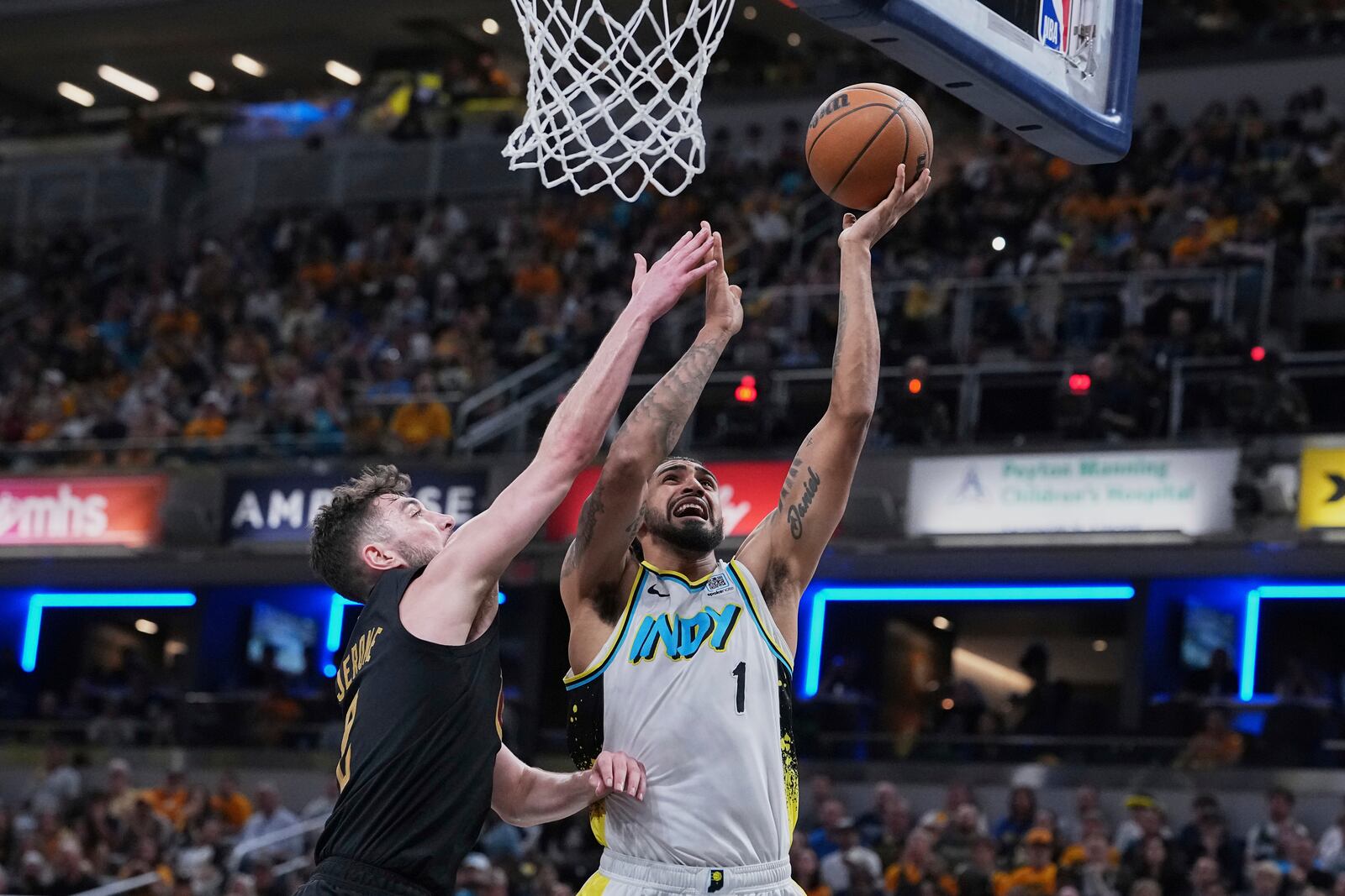 Indiana Pacers forward Obi Toppin (1) goes to the basket against Cleveland Cavaliers guard Ty Jerome in the second half of Game 4 in the Eastern Conference semifinals of the NBA basketball playoffs in Indianapolis, Sunday, May 11, 2025. (AP Photo/Michael Conroy)